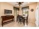 Bright dining area features a wooden table, four chairs, and a decorative cabinet with a display of decorative plates at 16406 W Peppertree Ct, Surprise, AZ 85387