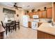 Bright kitchen with tiled floors, white appliances, and cozy breakfast nook at 16406 W Peppertree Ct, Surprise, AZ 85387