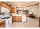 Bright kitchen showcases tile floors and a view into the adjacent living area at 16406 W Peppertree Ct, Surprise, AZ 85387