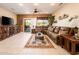 Comfortable living room with tile flooring, a ceiling fan, and an inviting sectional couch at 16406 W Peppertree Ct, Surprise, AZ 85387