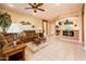 Cozy living area features tile flooring, stylish furniture, and an adjoining kitchen at 16406 W Peppertree Ct, Surprise, AZ 85387