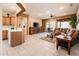 Spacious living room features tile flooring, a ceiling fan, and easy access to outdoor patio at 16406 W Peppertree Ct, Surprise, AZ 85387