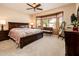 Spacious main bedroom with a large bed, a bay window with a bench, and a ceiling fan at 16406 W Peppertree Ct, Surprise, AZ 85387