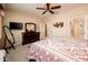 Bedroom with a queen bed, dresser, and a flat screen television mounted on the wall at 16406 W Peppertree Ct, Surprise, AZ 85387