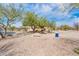 Scenic view of a neighborhood park with a bench, lush landscaping, and a walking path at 16406 W Peppertree Ct, Surprise, AZ 85387