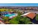 An aerial view of community center showing a pool, playground, basketball court, tennis court, and grassy field at 18079 W Sand Hills Dr, Surprise, AZ 85387