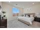 Serene main bedroom with soft carpet, a large window with natural light, and neutral decor at 18079 W Sand Hills Dr, Surprise, AZ 85387