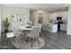 Open dining area adjacent to a modern kitchen with stainless appliances and a cozy breakfast nook at 18088 W Sand Hills Dr, Surprise, AZ 85387