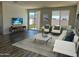 Bright living room with sliding glass door, comfortable seating, and contemporary decor at 18088 W Sand Hills Dr, Surprise, AZ 85387