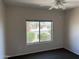 Bedroom with a window with views of the green landscape at 19746 N Wind Rose Way, Surprise, AZ 85374