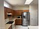 Kitchen featuring wood cabinets and stainless steel appliances at 19746 N Wind Rose Way, Surprise, AZ 85374