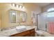 Charming bathroom with granite countertops, a vessel sink, stylish vanity, and a tiled shower at 2328 N 123Rd Ln, Avondale, AZ 85392