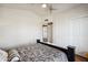 Bright bedroom with white walls, ceiling fan, and a bed with a patterned comforter at 2328 N 123Rd Ln, Avondale, AZ 85392