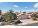 Charming home exterior with desert landscaping, tile roof, and spacious three-car garage at 2328 N 123Rd Ln, Avondale, AZ 85392