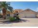 Charming single-Gathering home featuring a well-manicured lawn, lush palm, and a spacious three-car garage at 2328 N 123Rd Ln, Avondale, AZ 85392