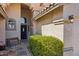 Inviting home entrance featuring a cozy bench, stylish light fixture, and manicured greenery at 2328 N 123Rd Ln, Avondale, AZ 85392