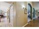 Hallway leading to the living area, featuring stainless steel appliances, and views of the fireplace at 2328 N 123Rd Ln, Avondale, AZ 85392