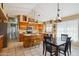 An open kitchen featuring oak cabinets, tile floors, stainless steel appliances and a breakfast nook at 2328 N 123Rd Ln, Avondale, AZ 85392