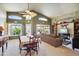 Bright living room featuring a high ceiling, large windows, and a comfortable seating area at 2328 N 123Rd Ln, Avondale, AZ 85392