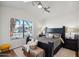 Stylish main bedroom with a large window and decorative accents for a peaceful living space at 2328 N 123Rd Ln, Avondale, AZ 85392