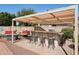 Backyard outdoor bar featuring seating, counter space, and a cozy outdoor area at 2328 N 123Rd Ln, Avondale, AZ 85392