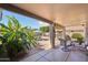 Relaxing covered patio with seating area overlooking the pool and lush greenery at 2328 N 123Rd Ln, Avondale, AZ 85392