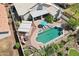 Aerial view of a private pool, covered patio, outdoor seating, and mature trees in the backyard at 2328 N 123Rd Ln, Avondale, AZ 85392