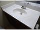 Bathroom sink with a dark wood vanity and a large decorative mirror above at 25176 W Cranston Ln, Buckeye, AZ 85326