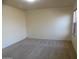 Neutral bedroom with a large window and neutral carpet at 25176 W Cranston Ln, Buckeye, AZ 85326