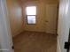 Neutral colored bedroom with window and door at 25176 W Cranston Ln, Buckeye, AZ 85326