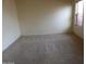 Neutral bedroom featuring a window, light-colored carpet, and plenty of space at 25176 W Cranston Ln, Buckeye, AZ 85326