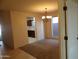 Open dining room features a chandelier and leads into a kitchen with dark wood cabinetry at 25176 W Cranston Ln, Buckeye, AZ 85326