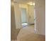 Hallway with neutral colored walls and tile flooring at 25176 W Cranston Ln, Buckeye, AZ 85326