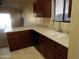 Well-lit kitchen featuring granite countertops and a large sink with a window above at 25176 W Cranston Ln, Buckeye, AZ 85326