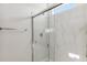 Stylish shower featuring marble walls and a sleek glass door at 25436 W Graham Trl, Buckeye, AZ 85326