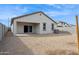 This backyard has low-maintenance desert landscaping and a covered patio for outdoor enjoyment at 25442 W Graham Trl, Buckeye, AZ 85326