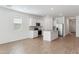 Bright kitchen featuring white cabinets, granite countertops, stainless steel appliances, and an island at 25442 W Graham Trl, Buckeye, AZ 85326