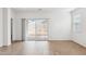 Bright living room with sliding glass doors to the backyard and wood-look tile flooring at 25442 W Graham Trl, Buckeye, AZ 85326