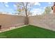 Private backyard with artificial grass and block fence is perfect for relaxation at 2727 N Price Rd # 26, Chandler, AZ 85224