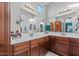 Spacious bathroom with double vanity, wood cabinets, and decorative lighting fixtures at 2727 N Price Rd # 26, Chandler, AZ 85224