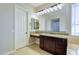 Lovely bathroom vanity with granite counters and bright lighting at 2830 E Fruitvale Ave, Gilbert, AZ 85297