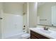 Bathroom featuring a tub with a shower, a toilet, and a dark wood vanity with an undermount sink at 2830 E Fruitvale Ave, Gilbert, AZ 85297