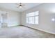 A spacious bedroom with neutral carpet, fan and view of another bedroom creates a tranquil retreat at 2830 E Fruitvale Ave, Gilbert, AZ 85297