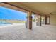 Covered patio with paver flooring, square posts, and views of the pool at 2830 E Fruitvale Ave, Gilbert, AZ 85297