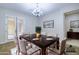 Elegant dining room featuring a dark wood table, neutral upholstered chairs, and a modern chandelier at 2830 E Fruitvale Ave, Gilbert, AZ 85297