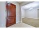 Welcoming entryway featuring tile flooring, a wood door, and an open view to living spaces at 2830 E Fruitvale Ave, Gilbert, AZ 85297