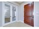 Elegant entryway featuring tiled floors, a solid wood door, and glass double doors at 2830 E Fruitvale Ave, Gilbert, AZ 85297