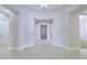 Bright foyer with tile flooring leading to a beautifully finished wooden front door at 2830 E Fruitvale Ave, Gilbert, AZ 85297