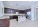 Modern kitchen with stainless steel appliances, granite countertops, and dark wood cabinetry at 2830 E Fruitvale Ave, Gilbert, AZ 85297