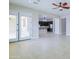 Spacious living room featuring tiled floors, ceiling fan, and an open layout connecting to the kitchen at 2830 E Fruitvale Ave, Gilbert, AZ 85297